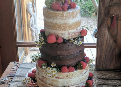 naked wedding cake with fresh flowers and fruit